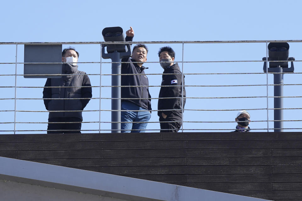 FILE - Visitors look at the northern side towards North Korea at the Imjingak Pavilion in Paju, South Korea, Sunday, Feb. 19, 2023. North Korea clams its nuclear weapons are combat ready, but some foreign governments and experts remain skeptical about how close the North has come in obtaining functioning nuclear arsenals. (AP Photo/Lee Jin-man, File)