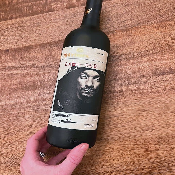 A bottle of red wine with Snoop Dogg on the label