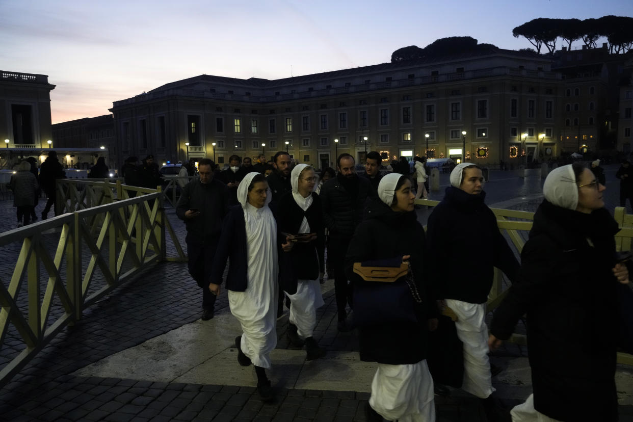 Nuns arrive at dawn to view the body of Pope Emeritus Benedict XVI as it lies in state in St. Peter's Basilica at the Vatican, Wednesday, Jan. 4, 2023. The Vatican announced that Pope Benedict died on Dec. 31, 2022, aged 95, and that his funeral will be held on Thursday, Jan. 5, 2023. (AP Photo/Gregorio Borgia)