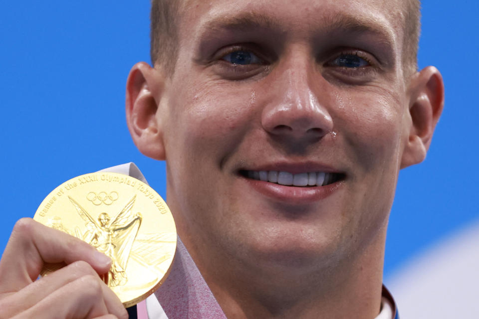 <p>TOPSHOT - Gold medallist USA's Caeleb Dressel poses with their medal after the final of the men's 100m freestyle swimming event during the Tokyo 2020 Olympic Games at the Tokyo Aquatics Centre in Tokyo on July 29, 2021. (Photo by Odd ANDERSEN / AFP) (Photo by ODD ANDERSEN/AFP via Getty Images)</p> 