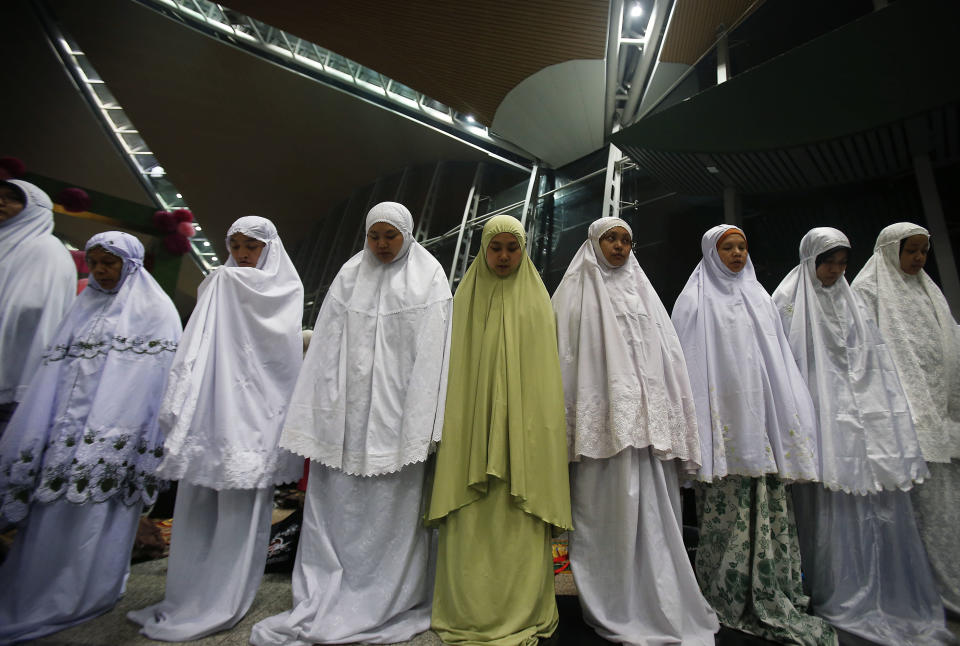 Muslim women offer prayers at the Kuala Lumpur International Airport for the missing Malaysia Airlines jetliner MH370, Thursday, March 13, 2014 in Sepang, Malaysia. Planes sent Thursday to check the spot where Chinese satellite images showed possible debris from the missing Malaysian jetliner found nothing, Malaysia's civil aviation chief said, deflating the latest lead in the six-day hunt. The hunt for the missing Malaysia Airlines flight 370 has been punctuated by false leads since it disappeared with 239 people aboard about an hour after leaving Kuala Lumpur for Beijing early Saturday. (AP Photo/Wong Maye-E)