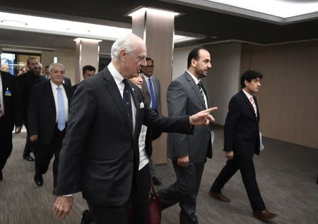 UN Special Envoy of the Secretary-General for Syria Staffan de Mistura (C), arrives with Syria's main opposition High Negotiations Committee (HNC) leader Nasr al-Hariri (2ndR) and delegates to take part in Syria peace talks at the European headquarters of the United Nations in Geneva, Switzerland, March 2, 2017. REUTERS/Philippe Desmazes