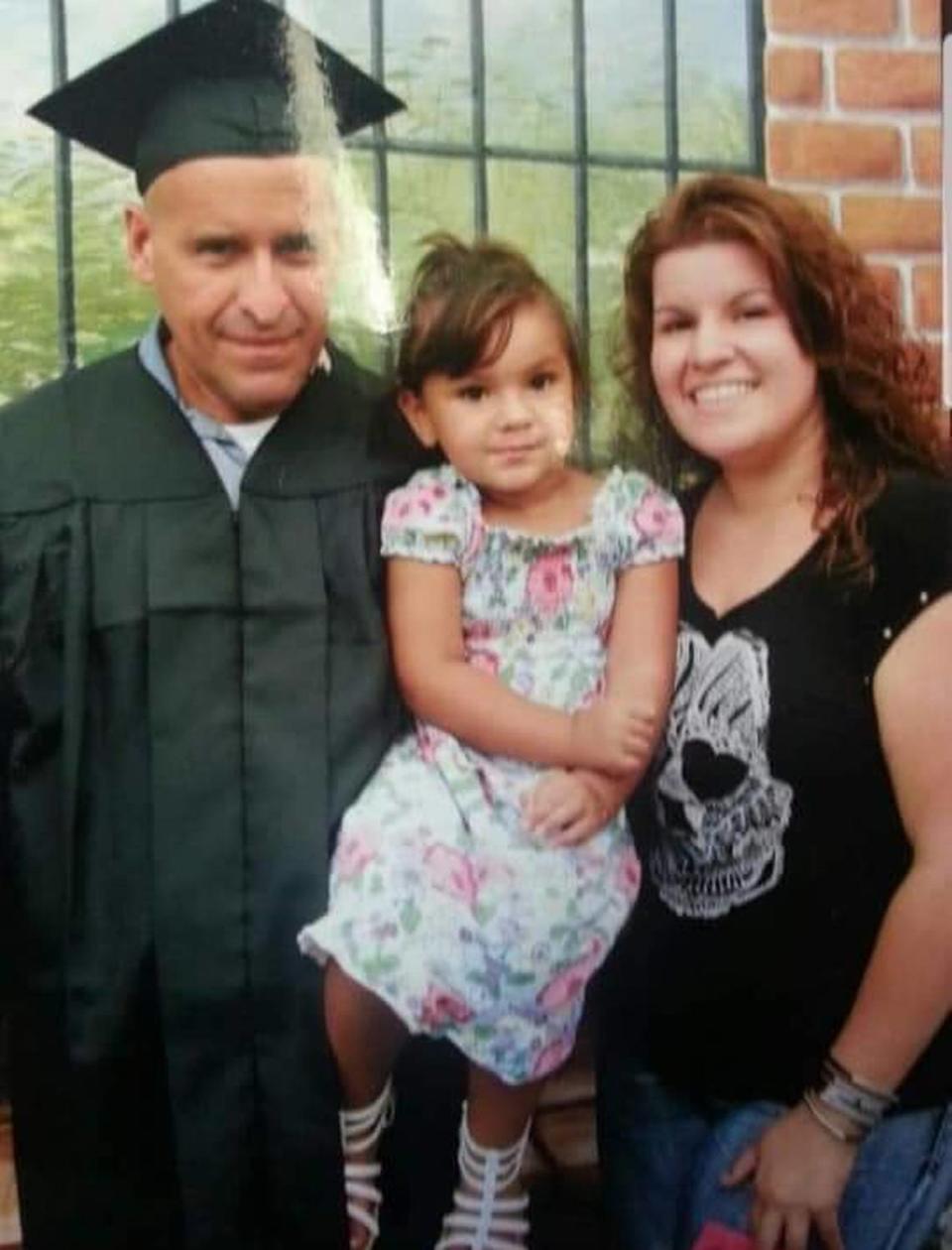 Henry Camacho with his daughter, Chrystal, and grandchild.