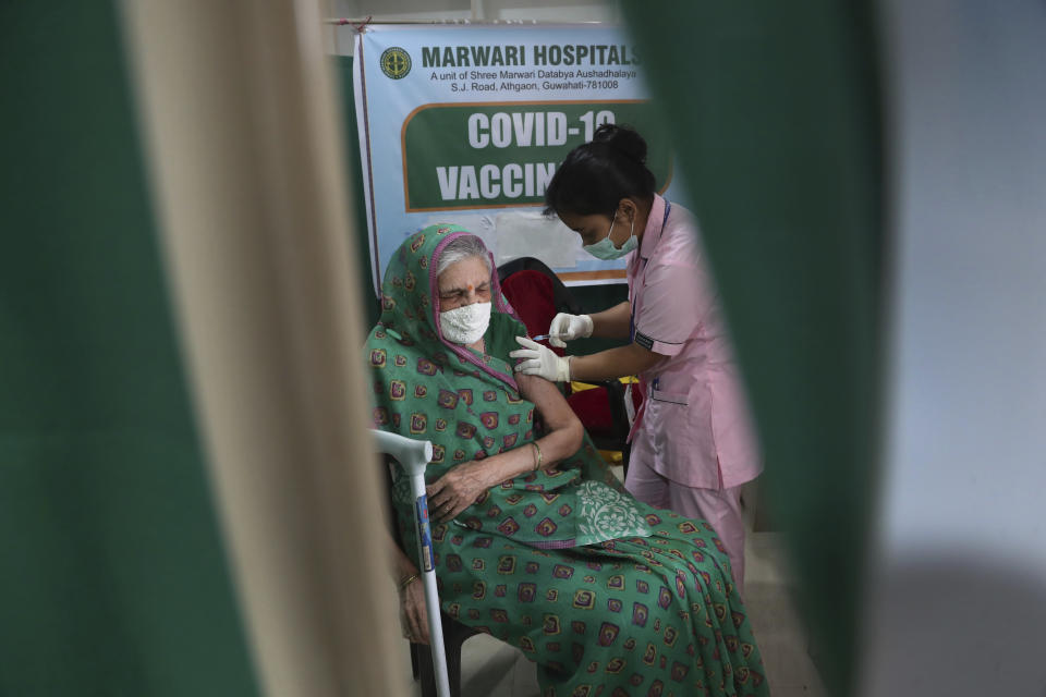 An elderly Indian woman receives COVID-19 vaccine at a private hospital in Gauhati, India, Thursday, March 11, 2021. Pandemic-weary and sequestered mostly in their homes for a year, India’s elderly are now standing in long lines at vaccination sites, then rolling up their sleeves to get shots protecting them against the coronavirus. (AP Photo/Anupam Nath)