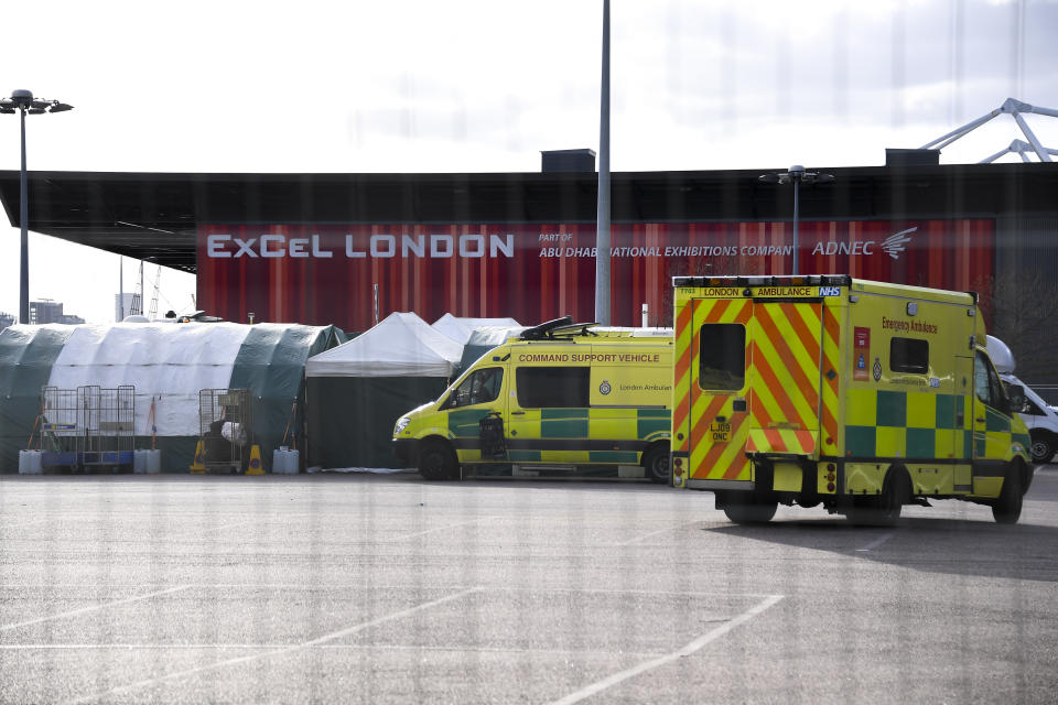 Ambulances and camp tents are seen outside the Excel in London, Saturday, March 28, 2020.The British Government announced Tuesday, that the ExCel Center in east London will become a 4,000 bed temporary hospital to deal with future coronavirus patients, to be called NHS Nightingale. The new coronavirus causes mild or moderate symptoms for most people, but for some, especially older adults and people with existing health problems, it can cause more severe illness or death.(AP Photo/Alberto Pezzali)