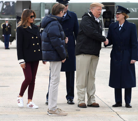 President Donald Trump, son Barron and first lady Melania Trump prepare to board Air Force One as they depart from Joint Base Andrews, Maryland, U.S., to visit tornado-devastated Alabama, March 8, 2019. REUTERS/Mike Theiler