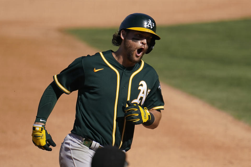 Oakland Athletics' Chad Pinder rounds the bases after hitting a three-run home run against the Houston Astros during the seventh inning of Game 3 of a baseball American League Division Series in Los Angeles, Wednesday, Oct. 7, 2020. (AP Photo/Marcio Jose Sanchez)