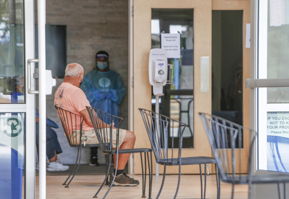 A man waits to be tested at the new COVID-19 testing site at Pinellas Community Church on Wednesday, July 29, 2020, in St. Petersburg, Fla. Residents are required to make an appointment beforehand. A new free testing site opened on Wednesday in south St. Petersburg with the help of New York Gov. Andrew Cuomo, who sent 7,500 tests to seed the site. (Jonah Hinebaugh/Tampa Bay Times via AP)