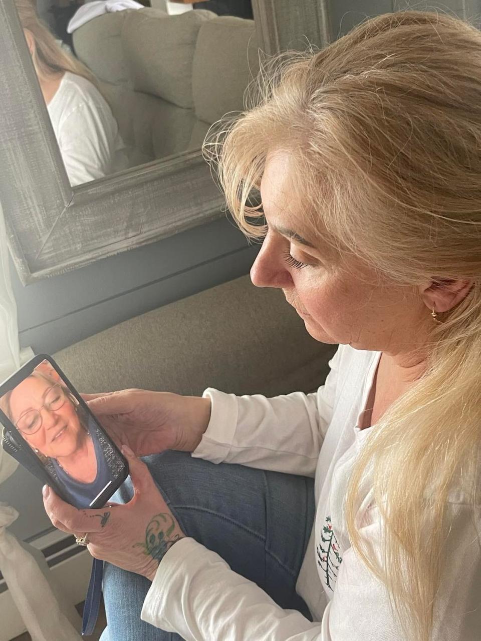 Pegi Dran Conte of Taunton holds a screenshot of her cousin Oksana Danilyuk of Ukraine, whom she has been speaking to on Facebook Video Chat since the Russian invasion of Ukraine and prior.