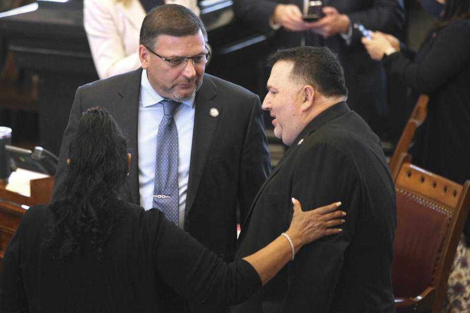 Kansas state Sen. Rick Kloos, center, R-Topeka, confers with Sens. Oletha Faust-Goudeau, D-Wichita, left, and Rob Olson, R-Olathe, right, before the start of a Senate session, Friday, April 9, 2021, in Topeka, Kan. Kloos is calling for a vote on removing Senate Majority Leader Gene Suellentrop, R-Wichita, following Suellentrop's arrest for drunken driving. (Andy Tsubasa Field/AP/Report for America)