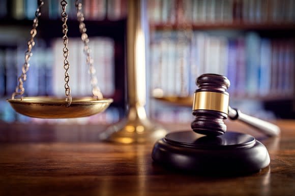 Close-up of judge's gavel on a wooden desk.