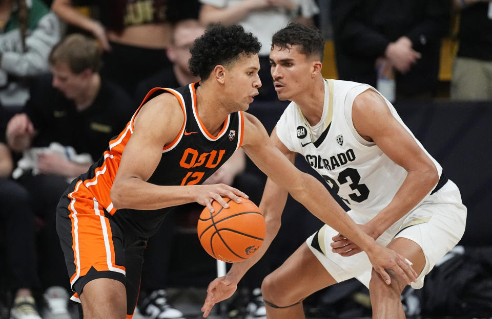 Oregon State forward Michael Rataj, left, drives past Colorado forward Tristan da Silva, right, in the second half of an NCAA college basketball game Saturday, Jan. 20, 2024, in Boulder, Colo. (AP Photo/David Zalubowski)