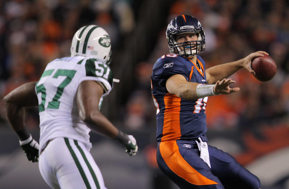 DENVER, CO - NOVEMBER 17: Tim Tebow #15 of the Denver Broncos throws a pass as he is pressured by Bart Scott #57 of the New York Jets in the first quarter at Invesco Field at Mile High on November 17, 2011 in Denver, Colorado. (Photo by Doug Pensinger/Getty Images)