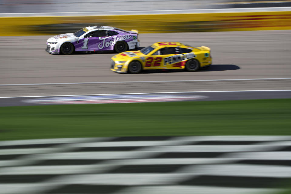 Joey Logano (22) passes Ross Chastain (1) during a NASCAR Cup Series auto race Sunday, Oct. 16, 2022, in Las Vegas. (AP Photo/John Locher)