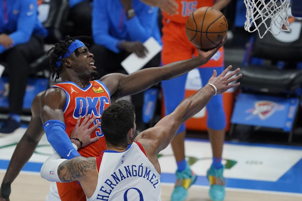 FILE - Oklahoma City Thunder forward Luguentz Dort, left, goes up for a shot in front of New Orleans Pelicans center Willy Hernangomez in Oklahoma City, in this April 29, 2021, file photo. Oklahoma City saw significant improvements from two of its young cornerstones in third-year guard Shai Gilgeous-Alexander and second-year guard Lu Dort.(AP Photo/Sue Ogrocki, File)