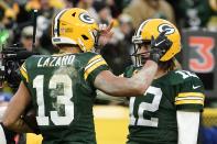 Green Bay Packers' Aaron Rodgers is congratulated after throwing his 443rd career touchdown pass, during the first half of an NFL football game against the Cleveland Browns on Saturday, Dec. 25, 2021, in Green Bay, Wis. The pass broke the Packers record held by Brett Favre. (AP Photo/Morry Gash)
