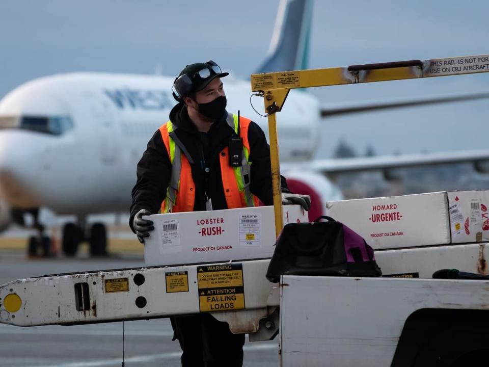 The union representing catering firm Gate Gourmet at Vancouver International Airport says workers have agreed to an improved benefit and wage package. (Darryl Dyck/Canadian Press - image credit)