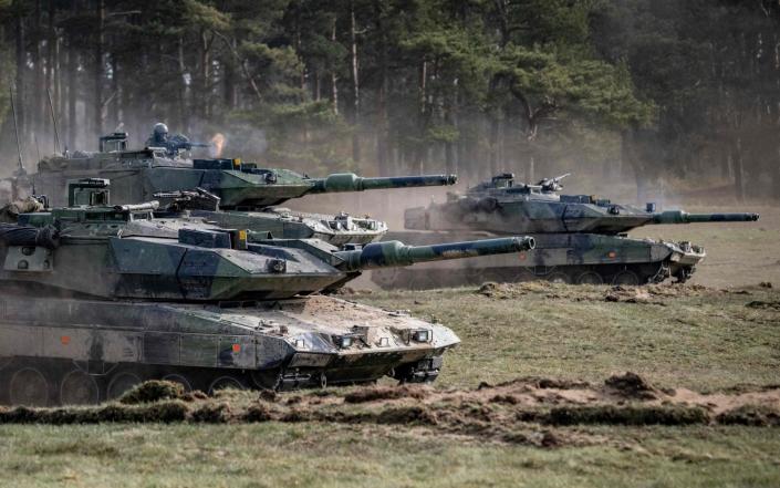 A tank commander fires his machine gun during an advance towards the enemy during the Aurora 23 military exercise at the Rinkaby firing range outside Kristianstad, Sweden on May 06, 2023 - Johna Nilsson/AFP