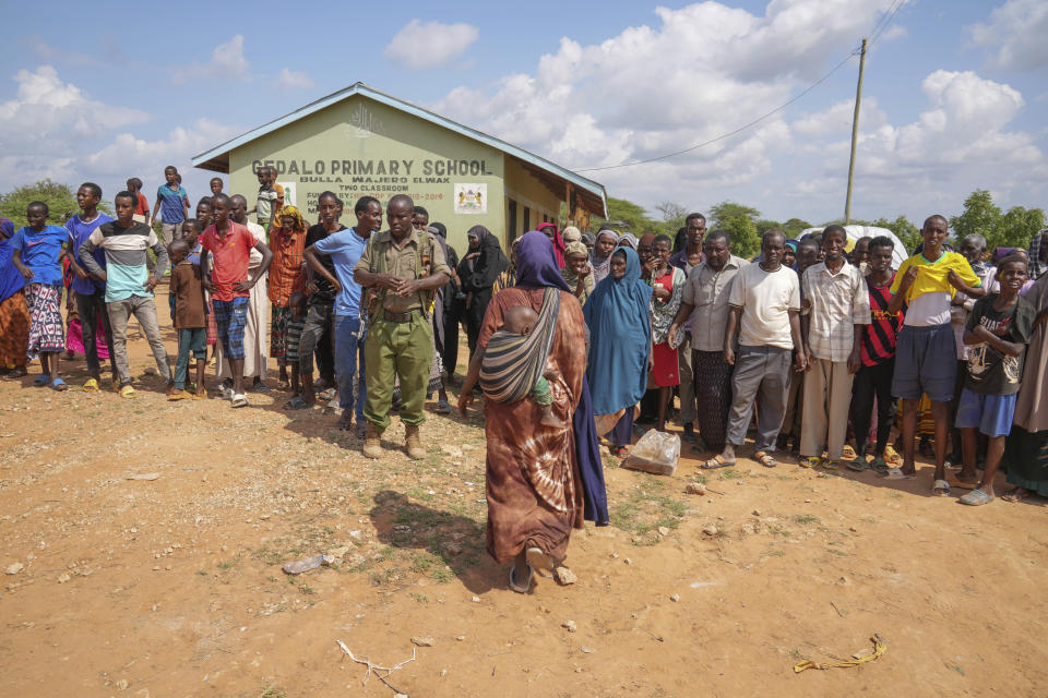 Residents gather for a planned distribution of food, after El Niño rains damaged their houses, in Mandera County, Kenya, Wednesday, Dec. 13, 2023. Rains began pounding the country in October. At the end of November Kenya President William Ruto convened an emergency cabinet meeting saying 38 of Kenya’s 47 counties had been affected by floods and mudslides made worse by the El Niño phenomenon. (AP Photo/Brian Inganga)