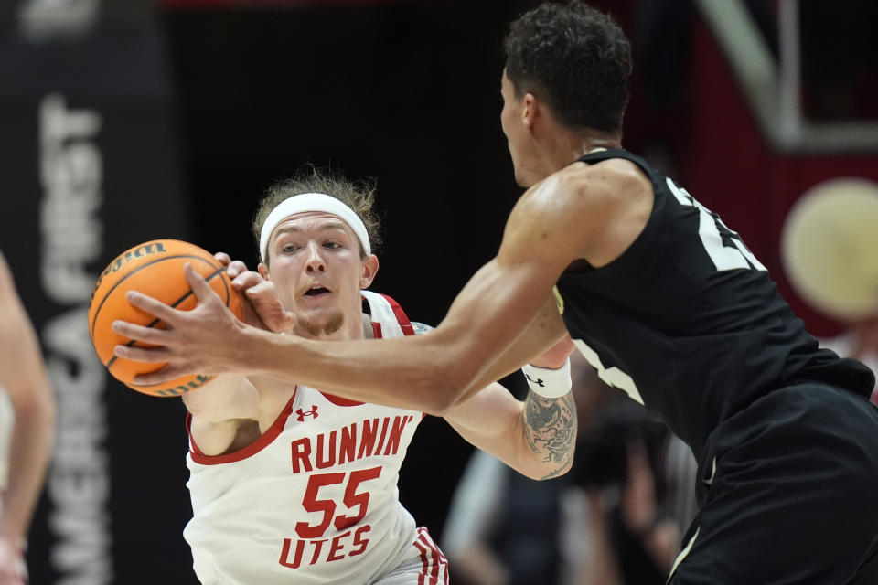 Utah guard Gabe Madsen (55) steals the ball from Colorado forward Tristan da Silva, right, during the second half of an NCAA college basketball game Saturday, Feb. 3, 2024, in Salt Lake City. (AP Photo/Rick Bowmer)