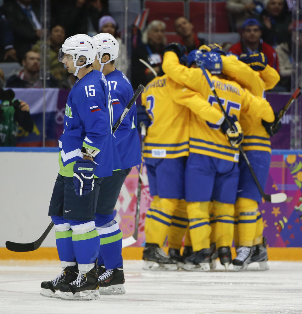 Slovenia defenseman Blaz Gregorc and defenseman Ziga Pavlin skate back to the bench after a goal by Sweden in the third period of a men's ice hockey game at the 2014 Winter Olympics, Wednesday, Feb. 19, 2014, in Sochi, Russia. (AP Photo/Julio Cortez)