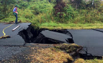 <p>A geologist inspects cracks on a road in Leilani Estates, following eruption of Kilauea volcano, Hawaii, May 17, 2018. (Photo: United States Geological Survey/Handout via Reuters) </p>