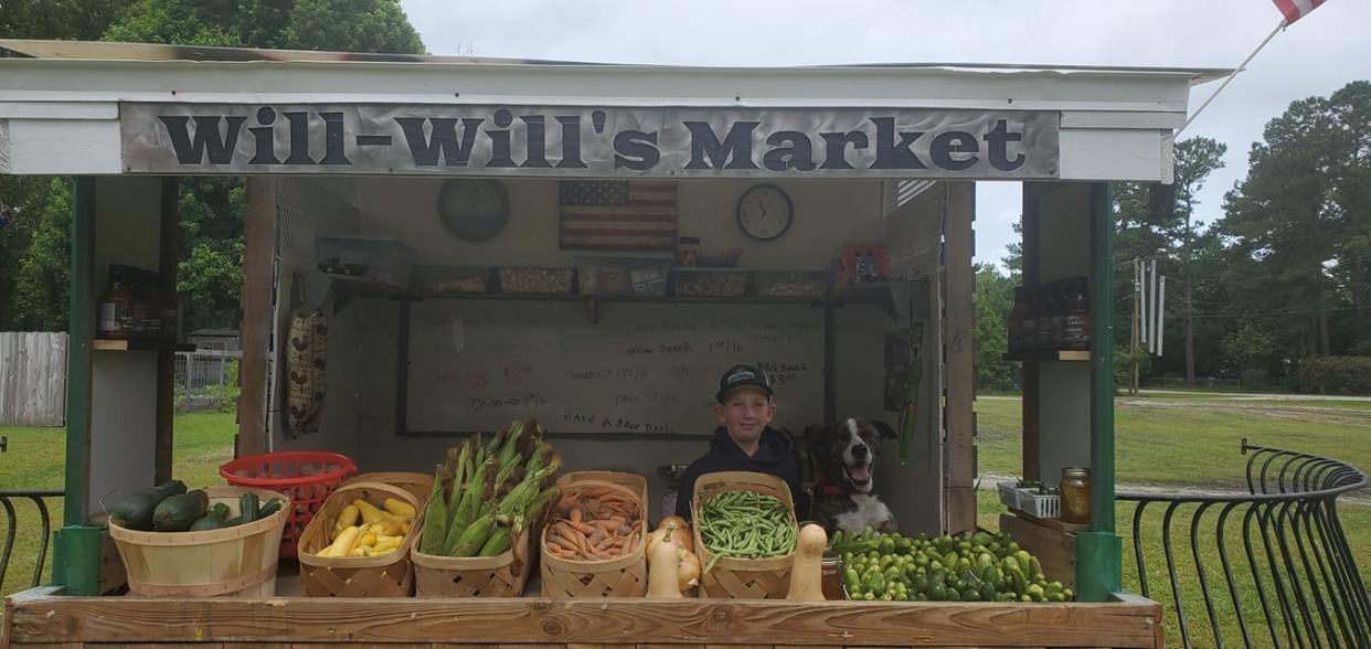 Will Peterson is ready to welcome customers at his produce stand in Rocky Point.