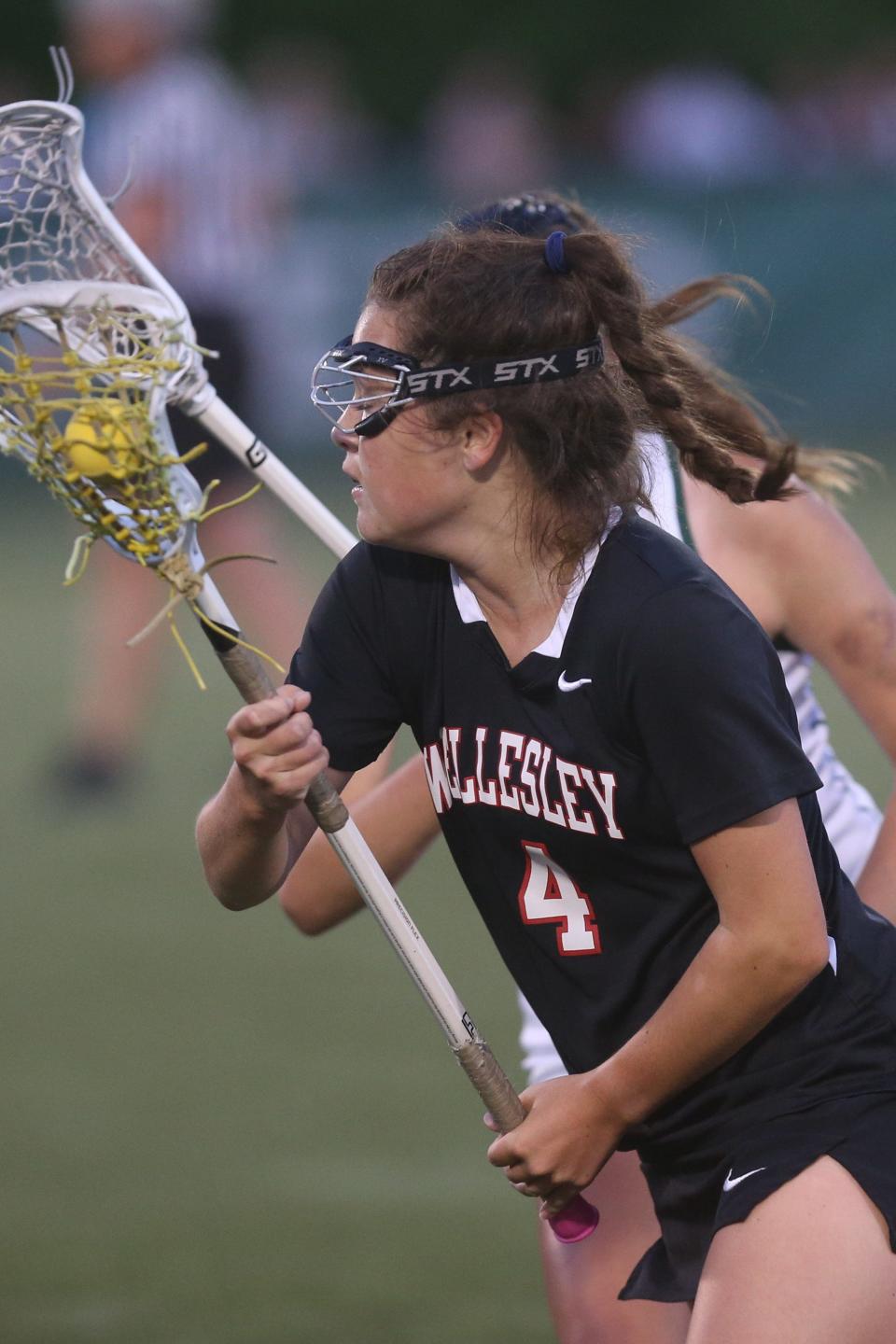 Wellesley freshman Kaitlyn Uller looks for an open teammate during the Division 1 state championship game against Westwood at Babson College in Wellesley on June 20, 2022.