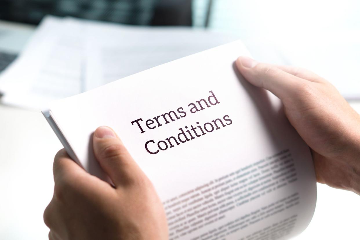 terms and conditions papers in hands