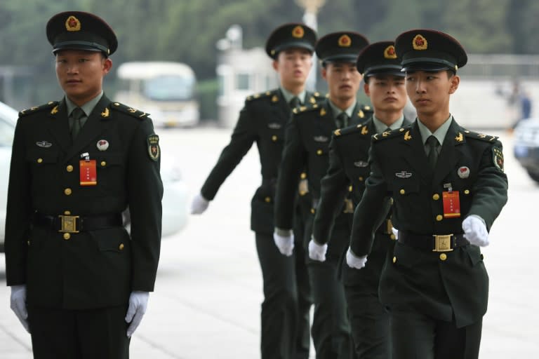 Chinese soldiers march outside the Great Hall of the People on the eve of the opening of the 19th Communist Party Congress