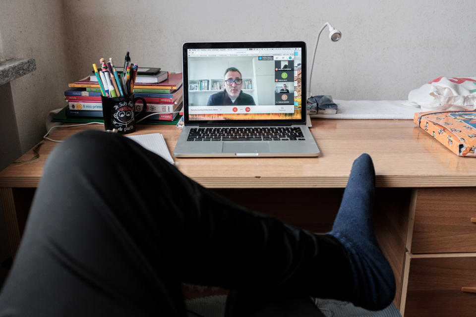 Life in lockdown: 35-year-old schoolteacher Marzio Toniolo takes a picture as he participates in a video conference call with colleagues and the headmaster of the primary school where he teaches, to see how everybody's classes are doing, at home in San Fiorano, one of the original 'red zone' towns in northern Italy that have been on lockdown since February, March 27, 2020. Toniolo has been documenting what life has been like for his family since quarantine began for them weeks before the rest of the country. Picture taken March 27, 2020. Marzio Toniolo/via REUTERS THIS IMAGE HAS BEEN SUPPLIED BY A THIRD PARTY. MANDATORY CREDIT