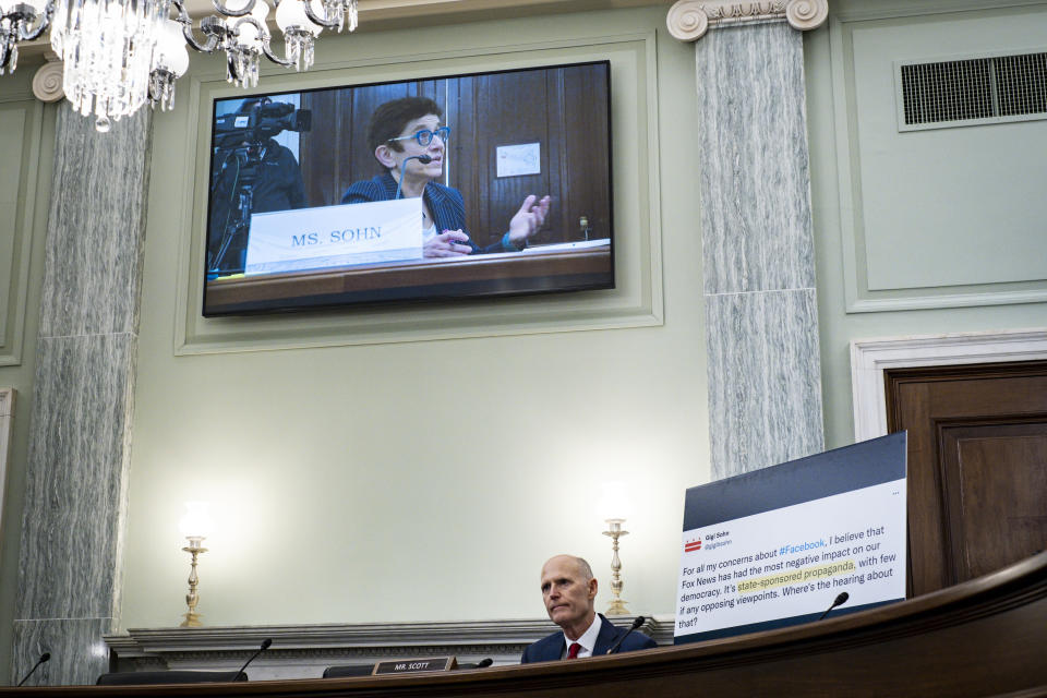 FILE - Gigi Sohn, seen on the screen above, answers questions from Sen. Rick Scott, R-Fla., about her previous Tweets as she testifies before the Senate Commerce, Science and Transportation Committee, Feb. 9, 2022, during her nomination hearing to serve on the Federal Communications Commission in Washington. Sohn withdrew her nomination, ditching her fight for a five-year term as an FCC commissioner. (Pete Marovich/The New York Times via AP, Pool, File)