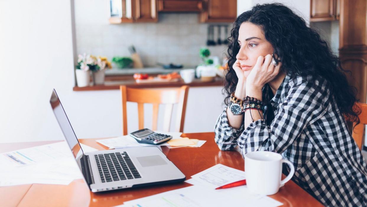 Young woman having problems and drinking coffee at home.