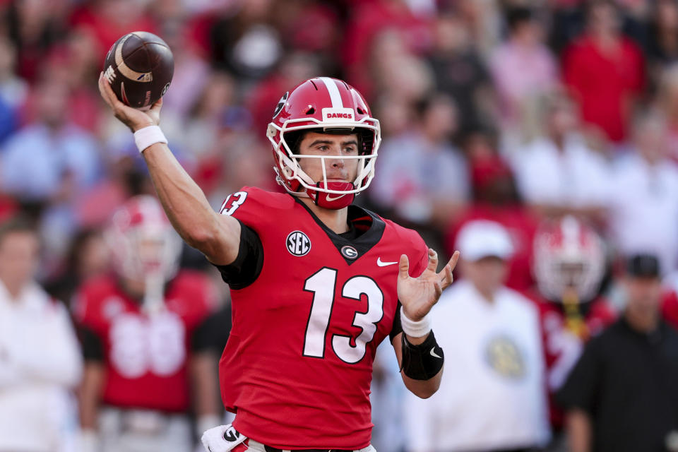 Georgia quarterback Stetson Bennett (13) throws a pass against Kentucky during the second half of an NCAA college football game Saturday, Oct. 16, 2021 in Athens, Ga. (AP Photo/Butch Dill)