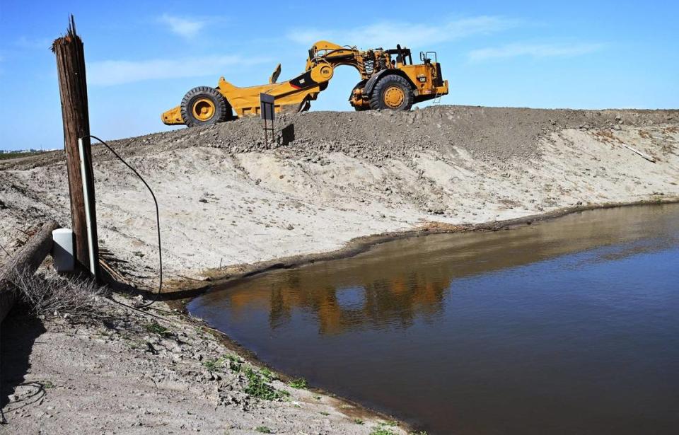 Heavy machinery continues raising the levee south of Corcoran in anticipation of snow melt raising Tule Lake, photogrpahed Tuesday afternoon, April 25, 2023.