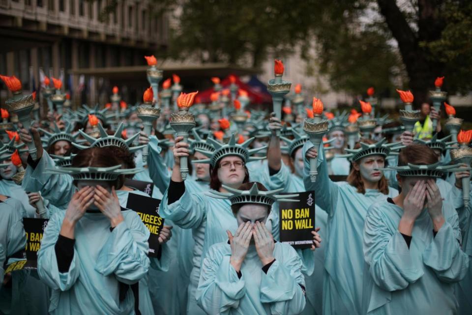 Protesters held up the Statue of Liberty's torch and covered their eyes (PA)