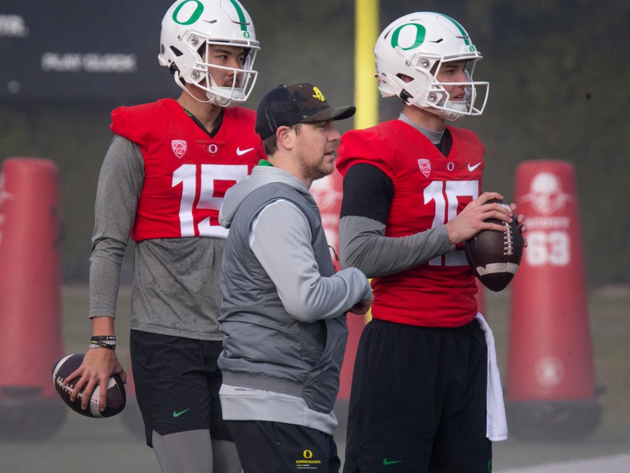 New Oregon offensive coordinator and quarterbacks coach Will Stein, center, works with quarterbacks Marcus Sanders, left, and Austin Novosad at the first practice of spring for Oregon football as they prepare for the 2023 season on Thursday March 16, 2023.