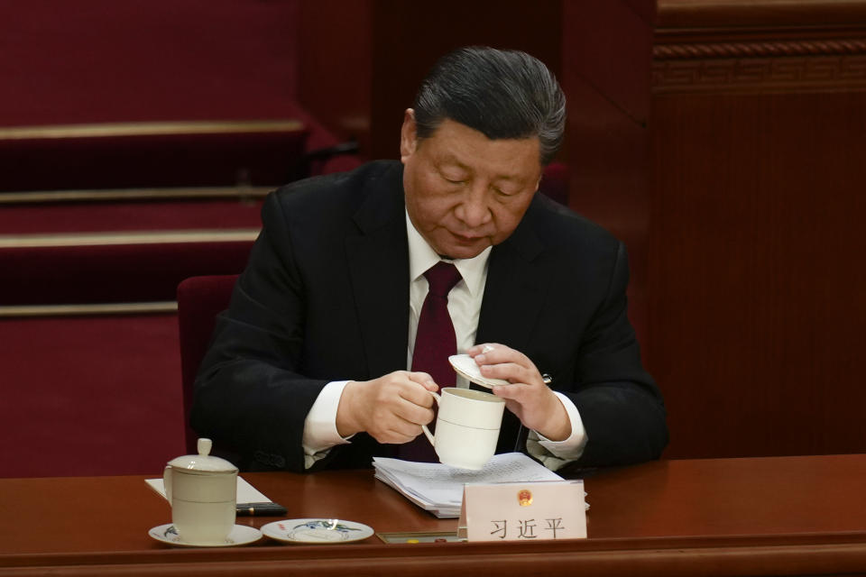Chinese President Xi Jinping drinks a cup of tea during the opening session of the National People's Congress (NPC) at the Great Hall of the People in Beijing, China, Tuesday, March 5, 2024. (AP Photo/Ng Han Guan)