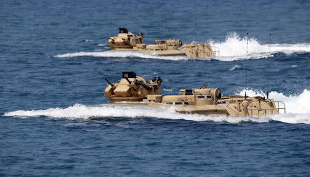 U.S. military forces aboard Amphibious Assault Vehicles (AAV) manuevre on South China Sea near the shore of San Antonio, Zambales during the annual "Balikatan" (shoulder-to-shoulder) war games with Filipino soldiers in northern Philippines in this April 21, 2015 file photo. REUTERS/Erik De Castro/Files