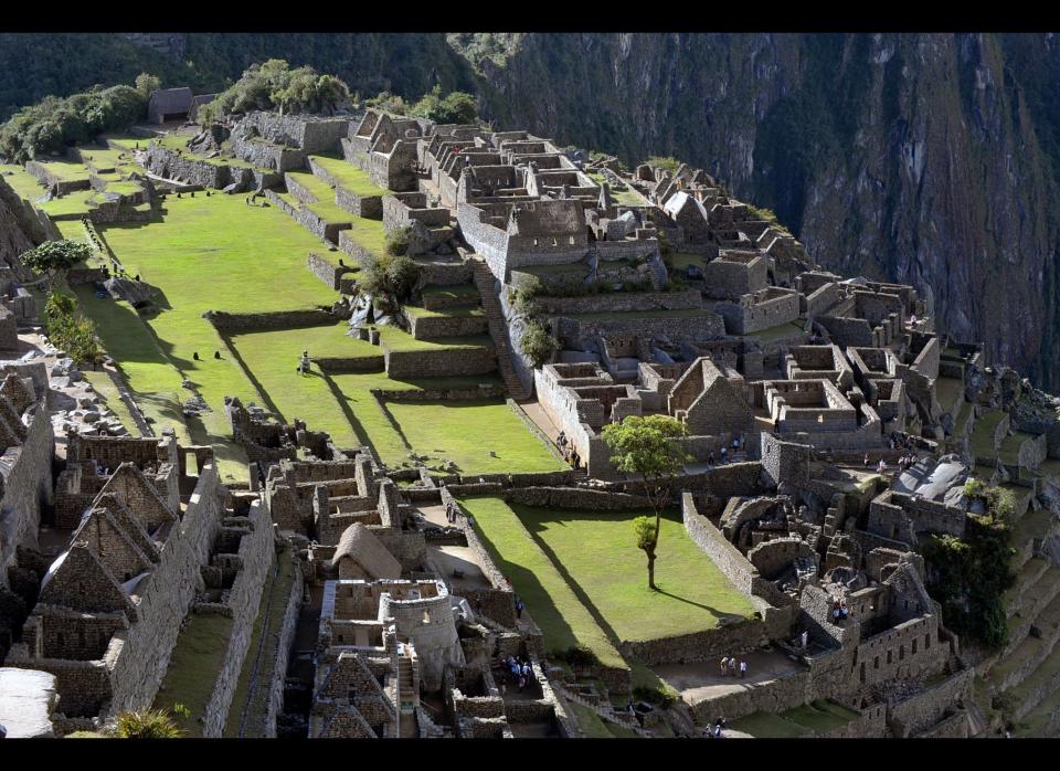 Tourists walk among the ruins of the Machu Picchu citadel, 130 km northwest of Cusco, Peru. CRIS BOURONCLE/AFP/Getty Images