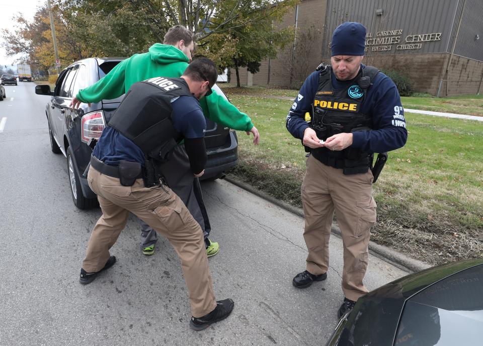 Ninth Mobile Detective Joseph Howell, left, searched a man during a traffic stop on Taylor Blvd on Nov. 16, 2018. Howell was among the Ninth Mobile officers suspended earlier this year for not reporting Ninth Mobile's Slushygate attacks, despite knowing about them.