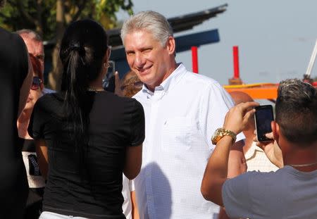 People take photographs of Cuba's First Vice-President Miguel Diaz-Canel after he cast his vote during an election of candidates for the national and provincial assemblies, in Santa Clara, Cuba March 11, 2018. REUTERS/Stringer/Files