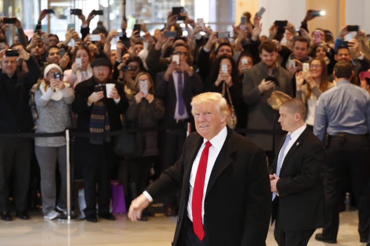 President-elect Donald Trump walks past a crowd as he leaves the New York Times building following a meeting, Tuesday, Nov. 22, 2016, in New York. (Photo: Mark Lennihan/AP)