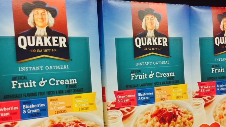 Closeup of boxes of Quaker oatmeal on a grocery shelf