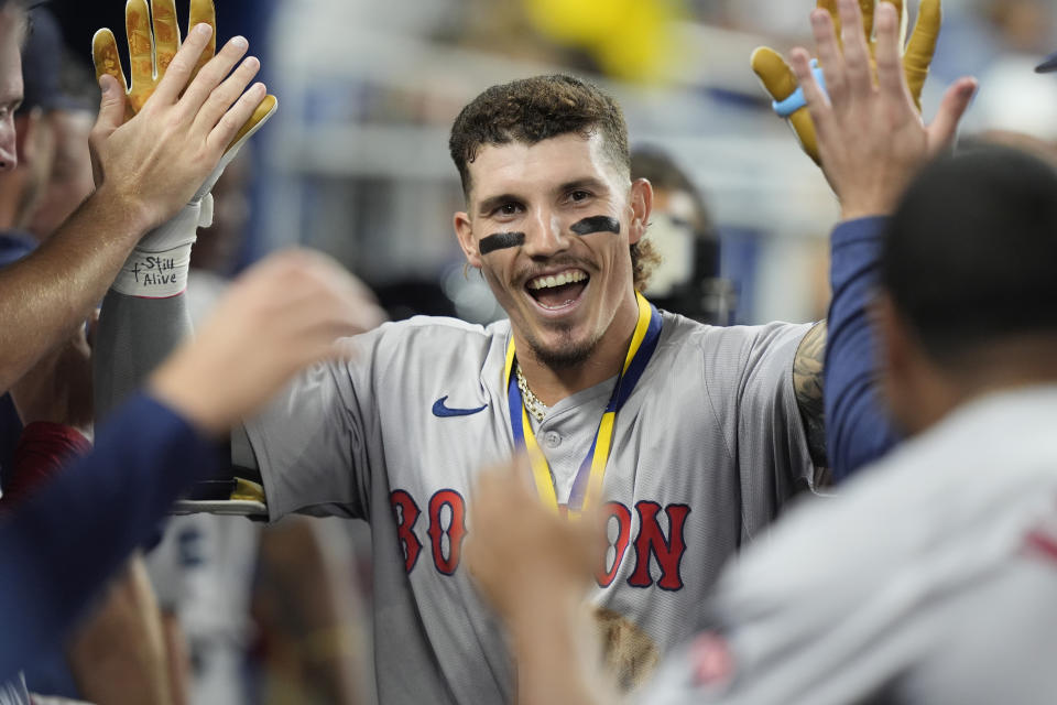 Boston Red Sox's Jarren Duran celebrates with the team after hitting a home run during the eighth inning of a baseball game against the Miami Marlins, Tuesday, July 2, 2024, in Miami. The Red Sox defeated the Marlins 8-3. (AP Photo/Marta Lavandier)