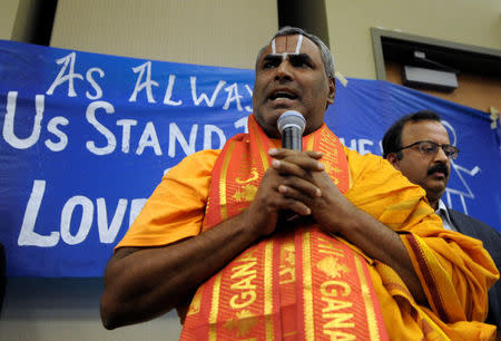 Srinivasacharyulu, from the Hindu Temple of Kansas City, prays during a vigil for Srinivas Kuchibhotla, an Indian engineer who was shot and killed, at a conference center in Olathe, Kansas, U.S., February 26, 2017. REUTERS/Dave Kaup