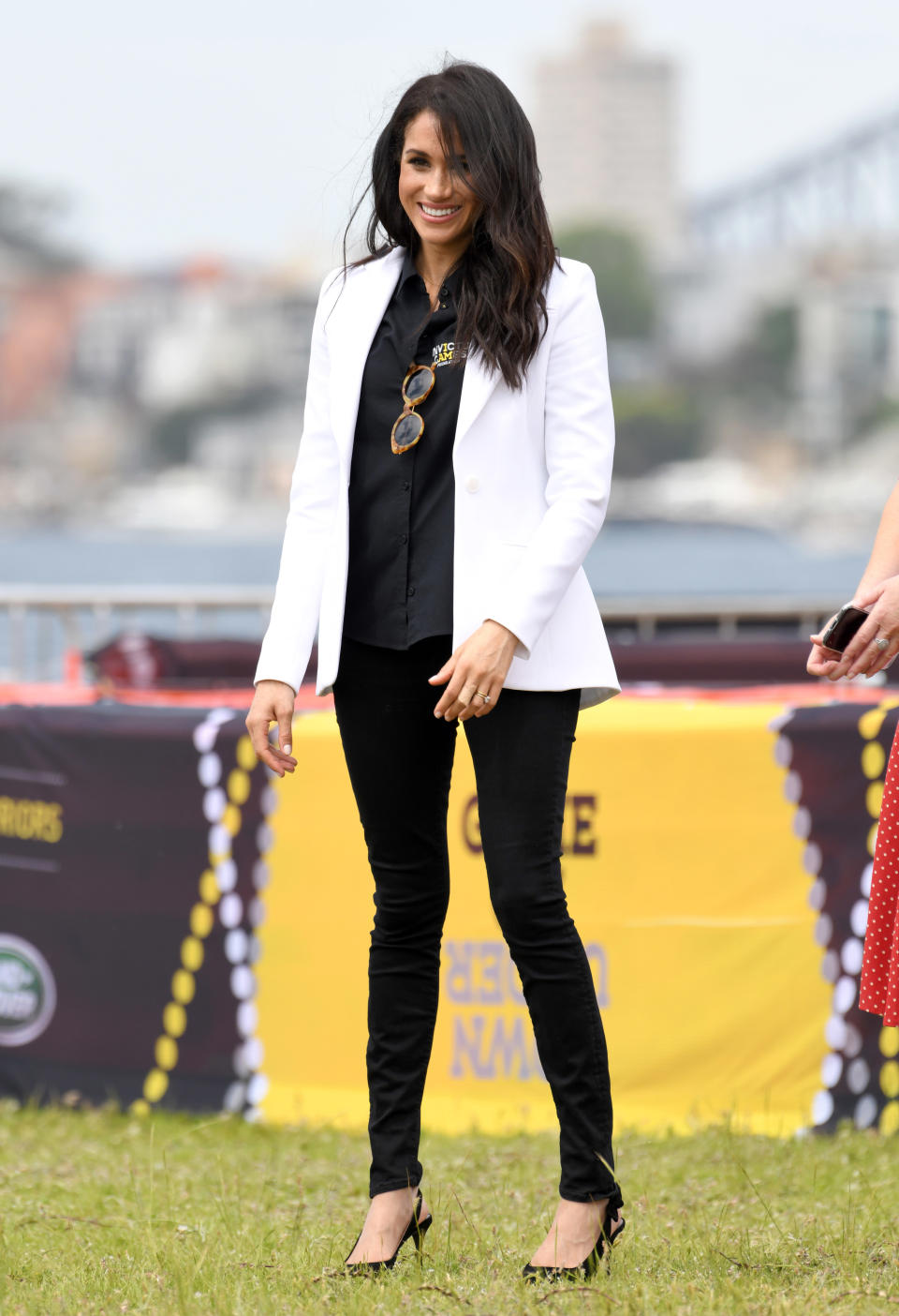 <p>For an Invictus Games event on day six of the couple’s royal tour, Meghan teamed a white Altuzarra blazer with an Invictus Sydney shirt. She finished the ensemble with £159 Mother Demin jeans, $240 (approx £184) Illesteva sunglasses and her go-to £566 Tabitha Simmons pumps. <em>[Photo: Getty]</em> </p>