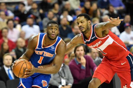 Jan 17, 2019; London, United Kingdom; New York Knicks guard Emmanuel Mudiay (1) drives to the basket past Washington Wizards forward Trevor Ariza (1) during the third quarter at The O2 Arena. Mandatory Credit: Steve Flynn-USA TODAY Sports