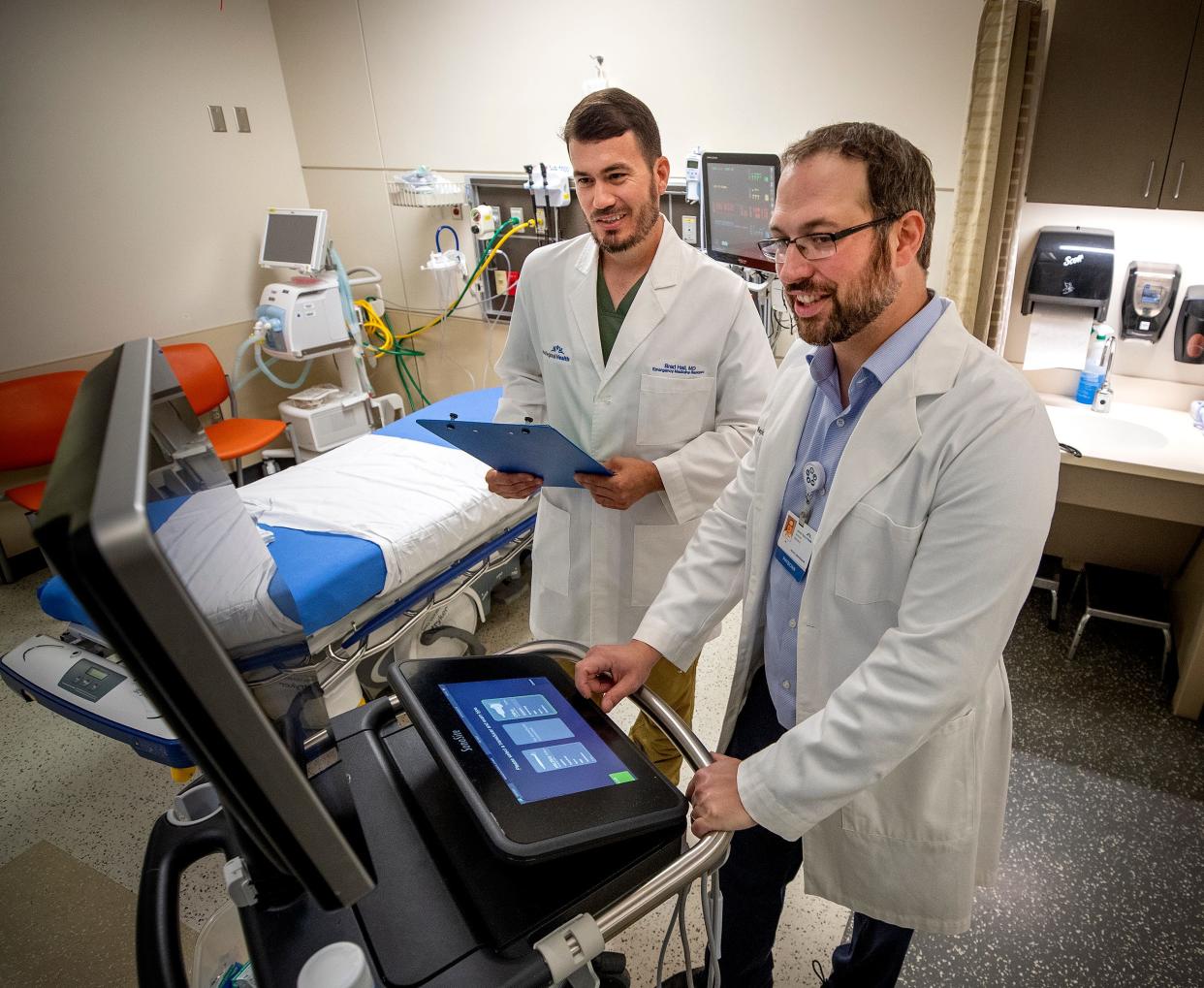 First year resident Dr. Brad Hall, left, works with Dr. Andrew Barbera, program director for the Emergency Medicine Residency Program at Lakeland Regional Health in Lakeland last week. Lakeland Regional Health is welcoming its first class of resident physicians marking its start as a teaching hospital.