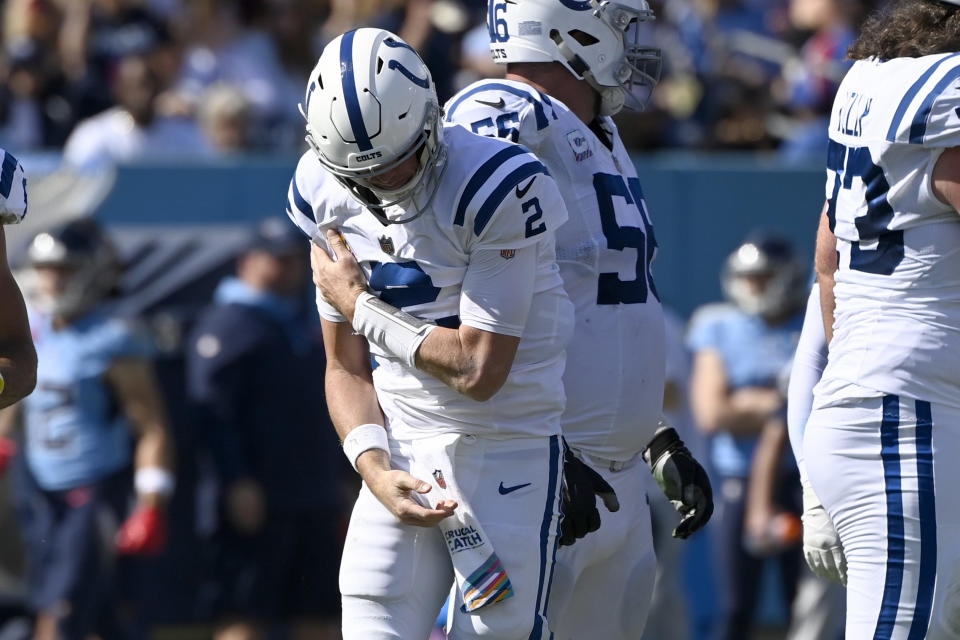 Indianapolis Colts quarterback Matt Ryan holds his shoulder after being sacked during the first half of an NFL football game against the Indianapolis Colts Sunday, Oct. 23, 2022, in Nashville, Tenn. (AP Photo/Mark Zaleski)